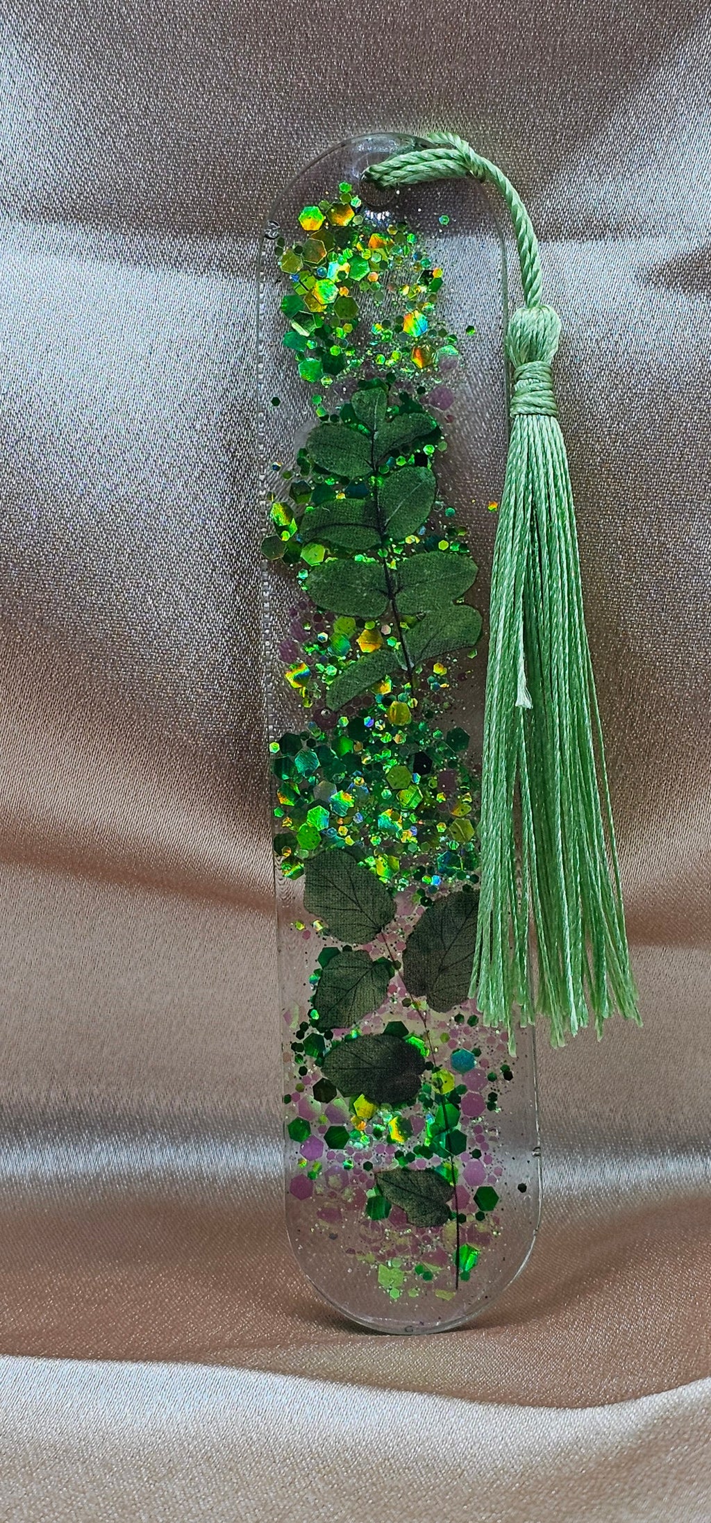 Handmade enchanted forest resin bookmark with real pressed ferns, holographic glitter & sage tassel. Cottagecore & fairycore book accessory handmade in Australia.