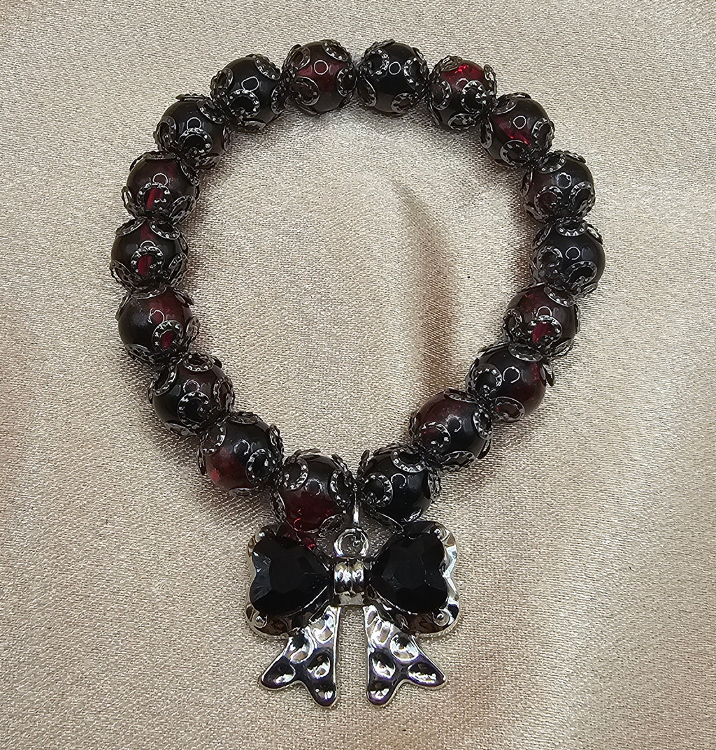 Handmade black bow bracelet with gothic red and black beads and bow charm, dark coquette jewellery Australia