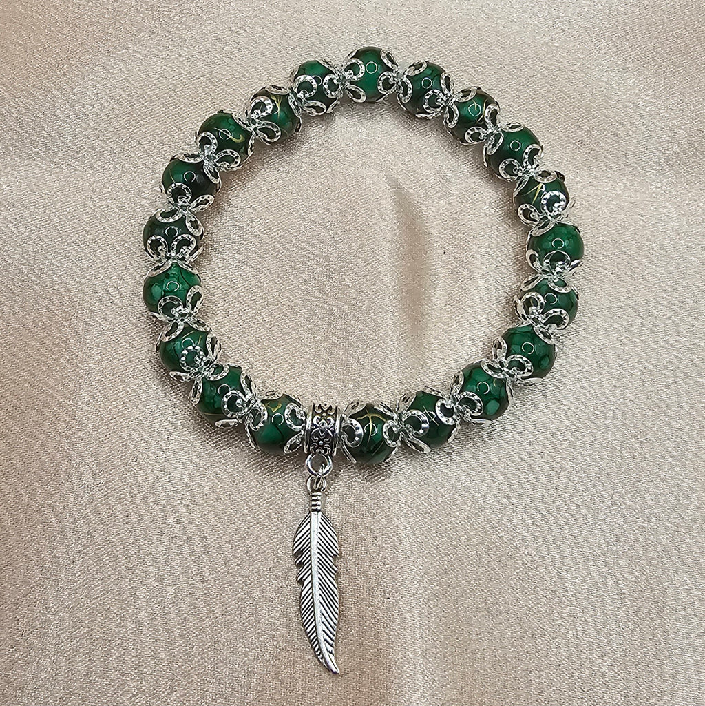 Handmade green marbled beaded bracelet with silver feather charm and filigree, green witch jewellery Australia