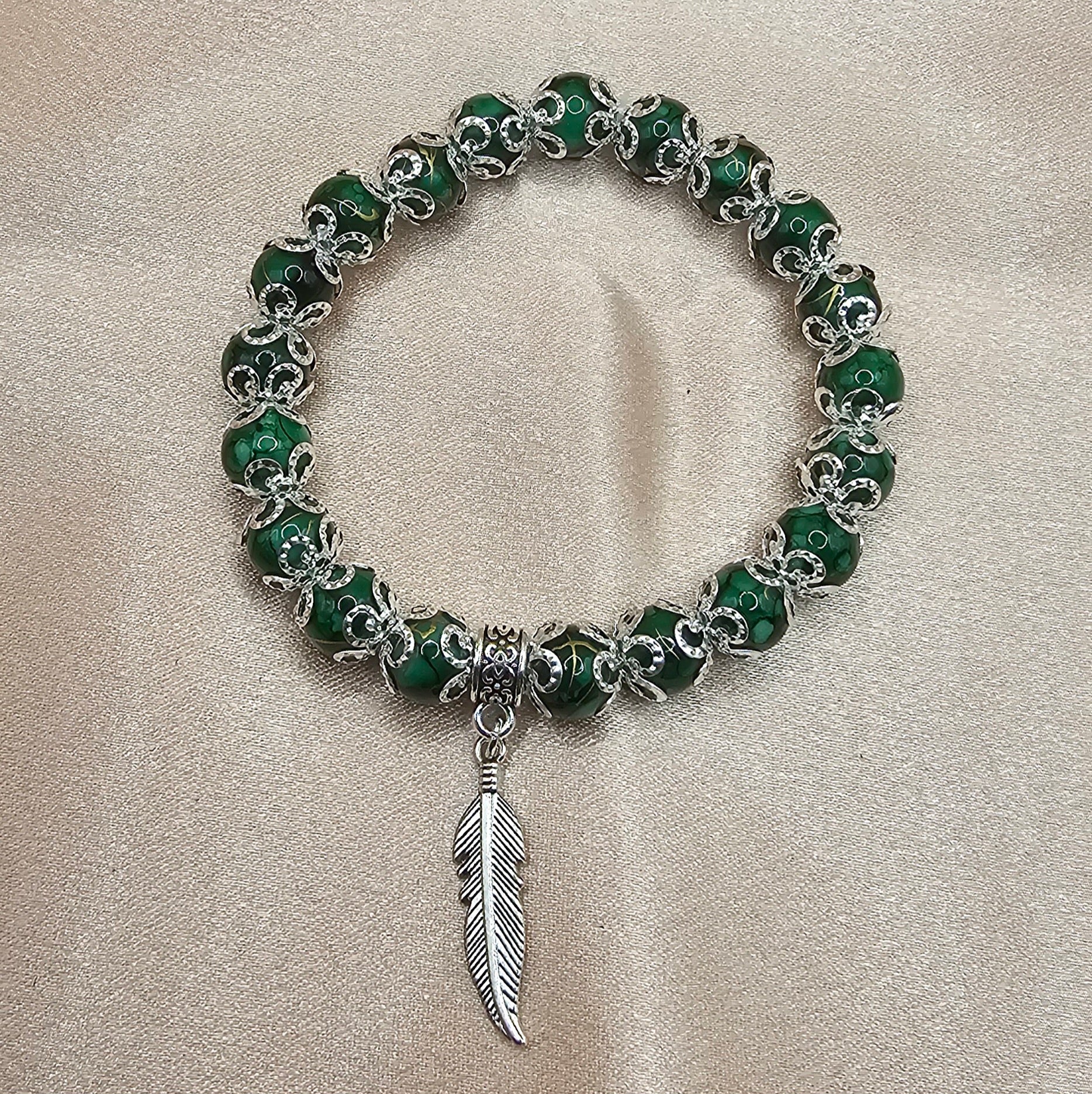 Handmade green marbled beaded bracelet with silver feather charm and filigree, green witch jewellery Australia