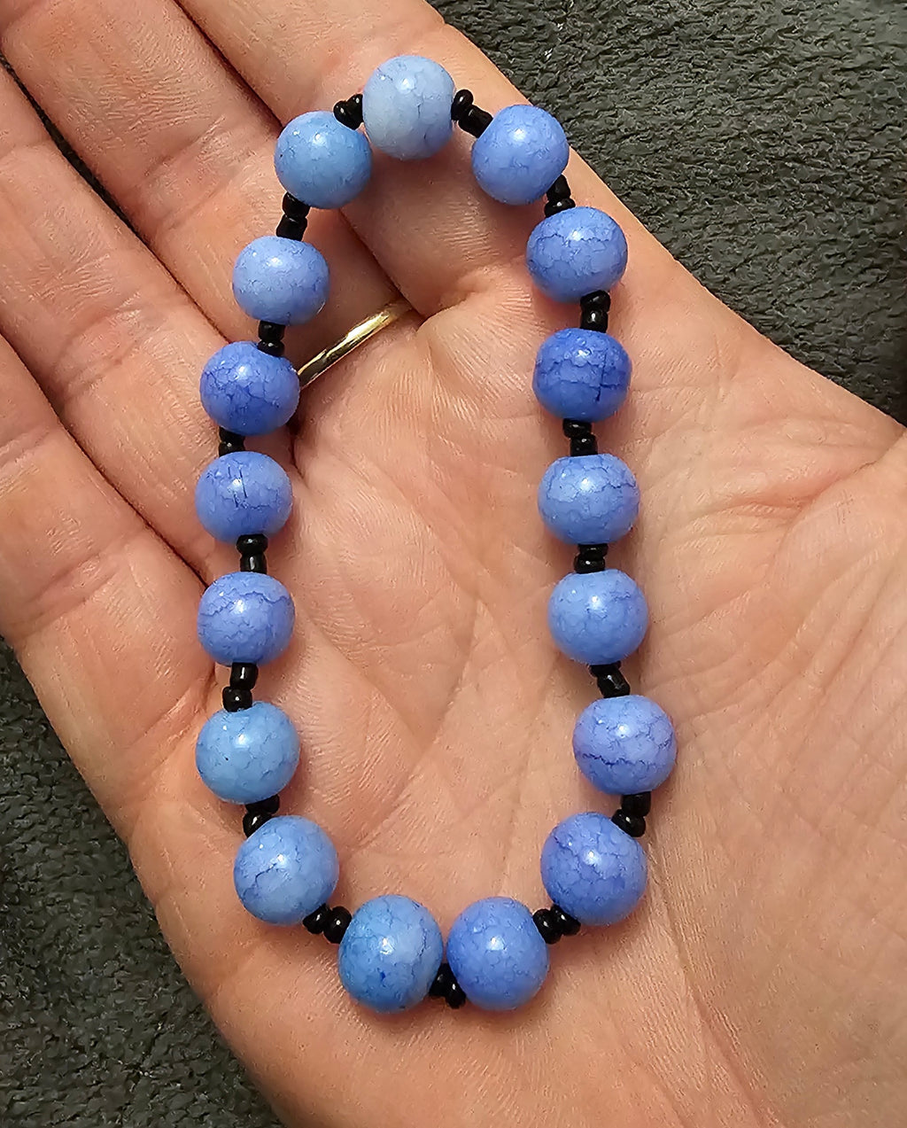 Handmade blue beaded bracelet with faceted sky blue and black accents, mooncore jewellery Australia