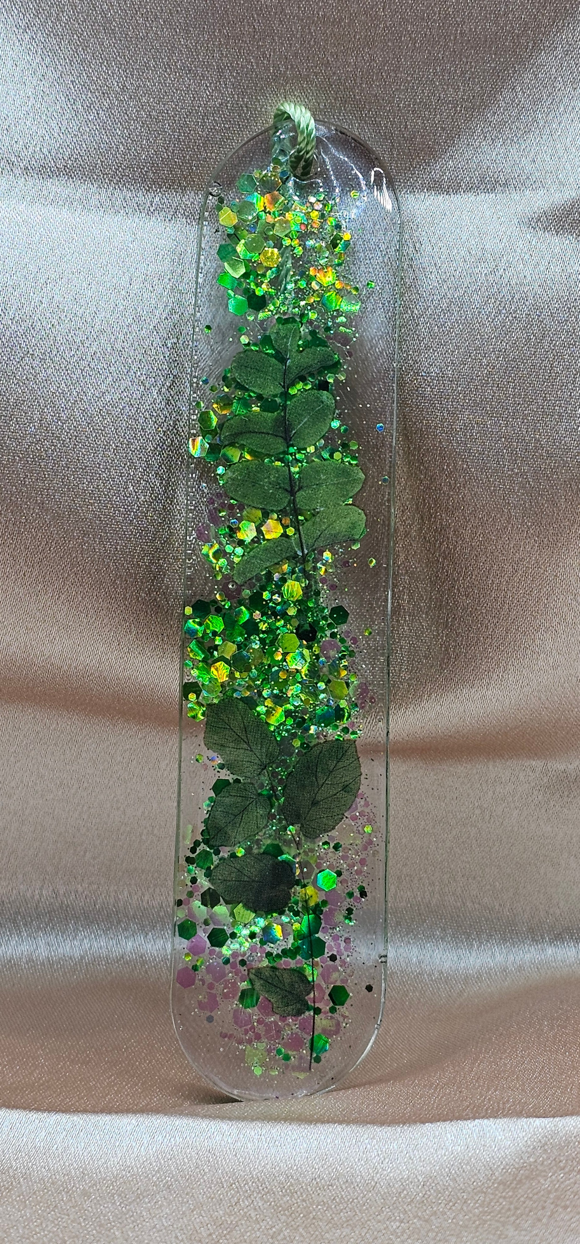 Handmade enchanted forest resin bookmark with real pressed ferns, holographic glitter & sage tassel. Cottagecore & fairycore book accessory handmade in Australia.