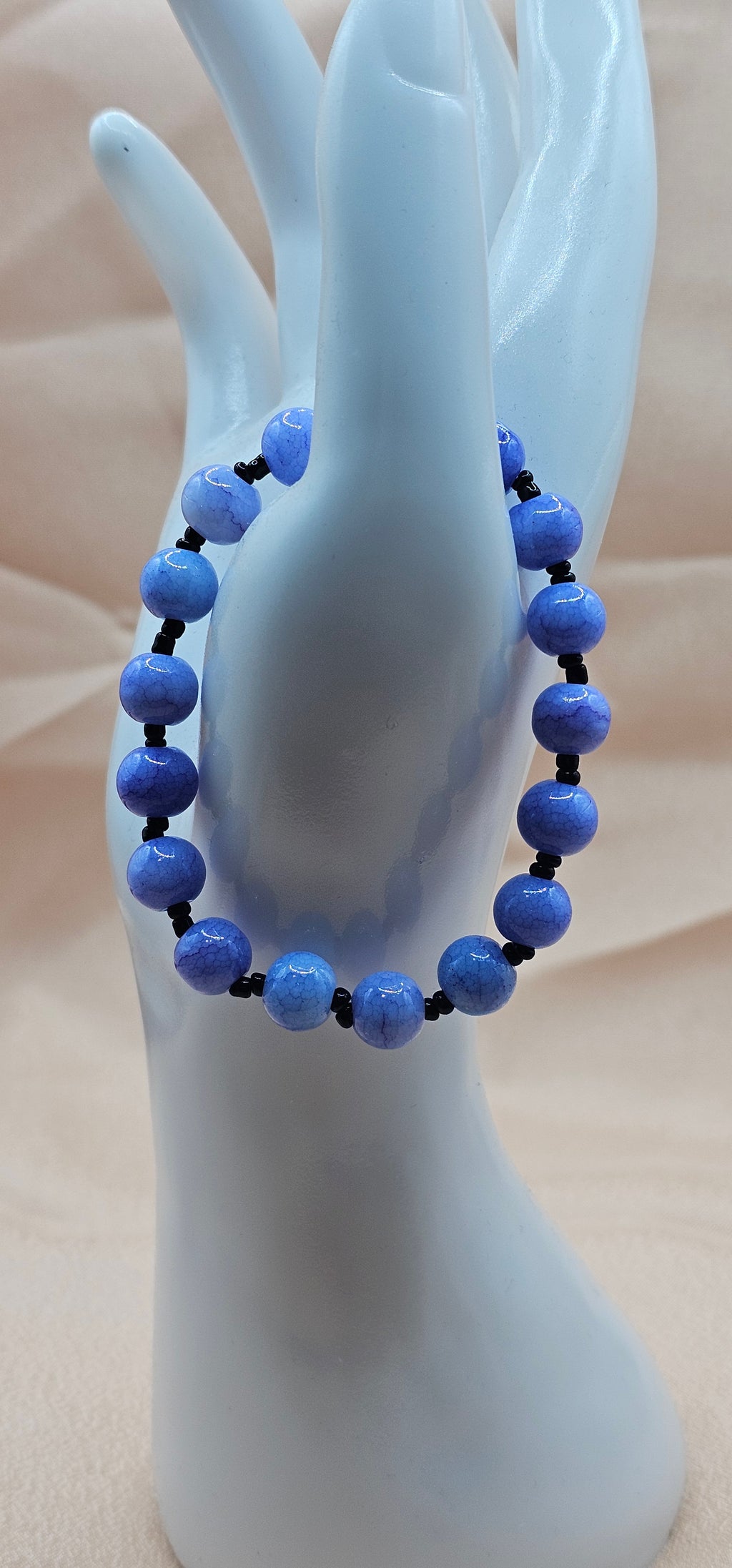 Handmade blue beaded bracelet with faceted sky blue and black accents, mooncore jewellery Australia