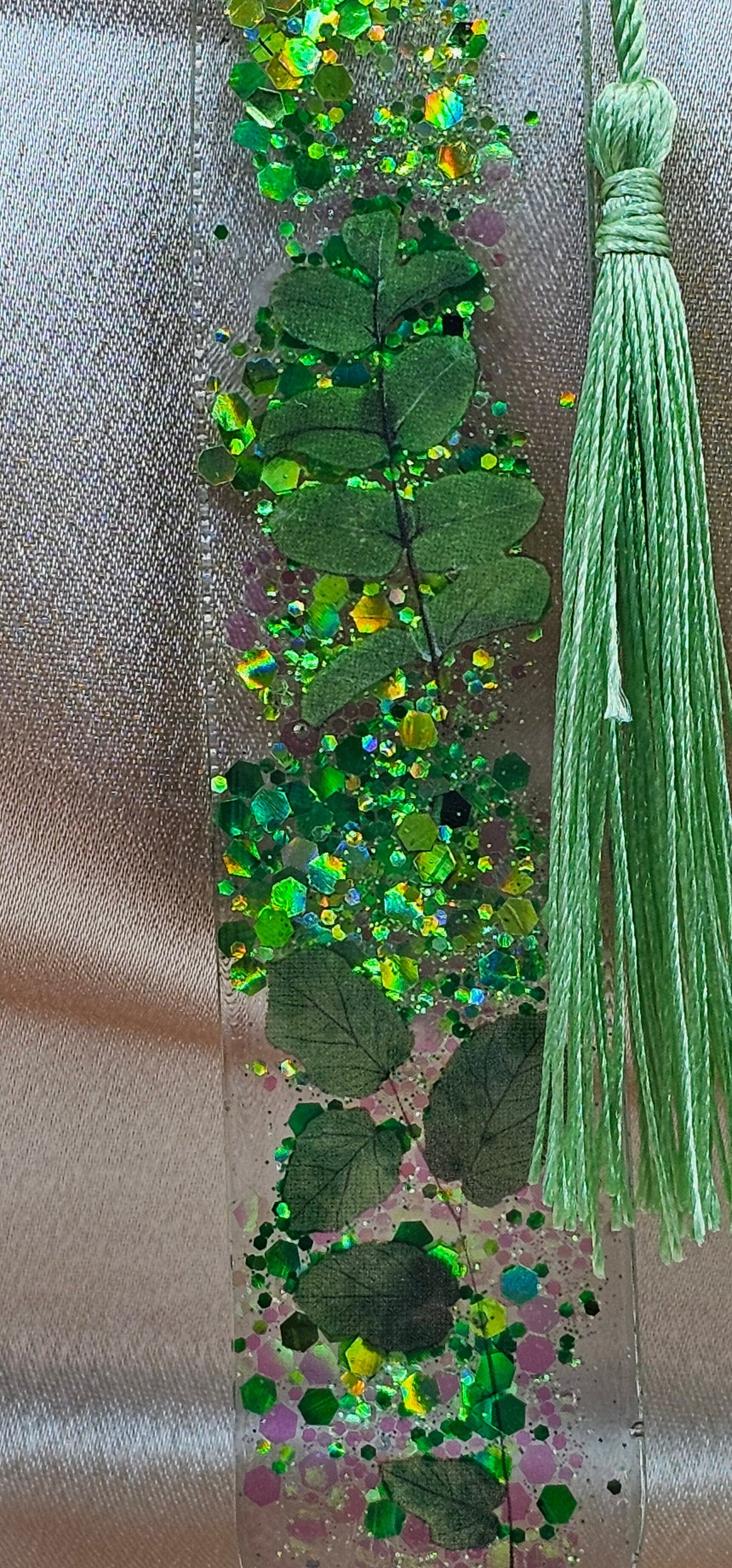 Handmade enchanted forest resin bookmark with real pressed ferns, holographic glitter & sage tassel. Cottagecore & fairycore book accessory handmade in Australia.
