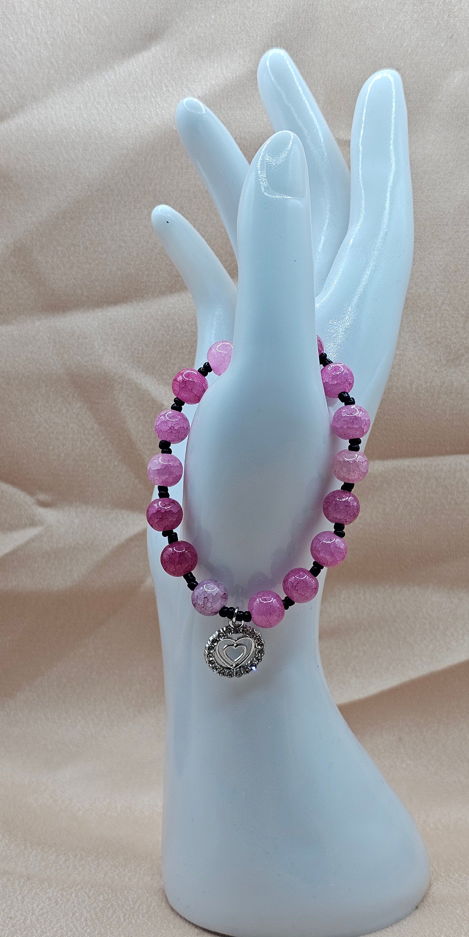 Handmade pink beaded bracelet with rhinestone heart charm and black accents, coquette jewellery Australia