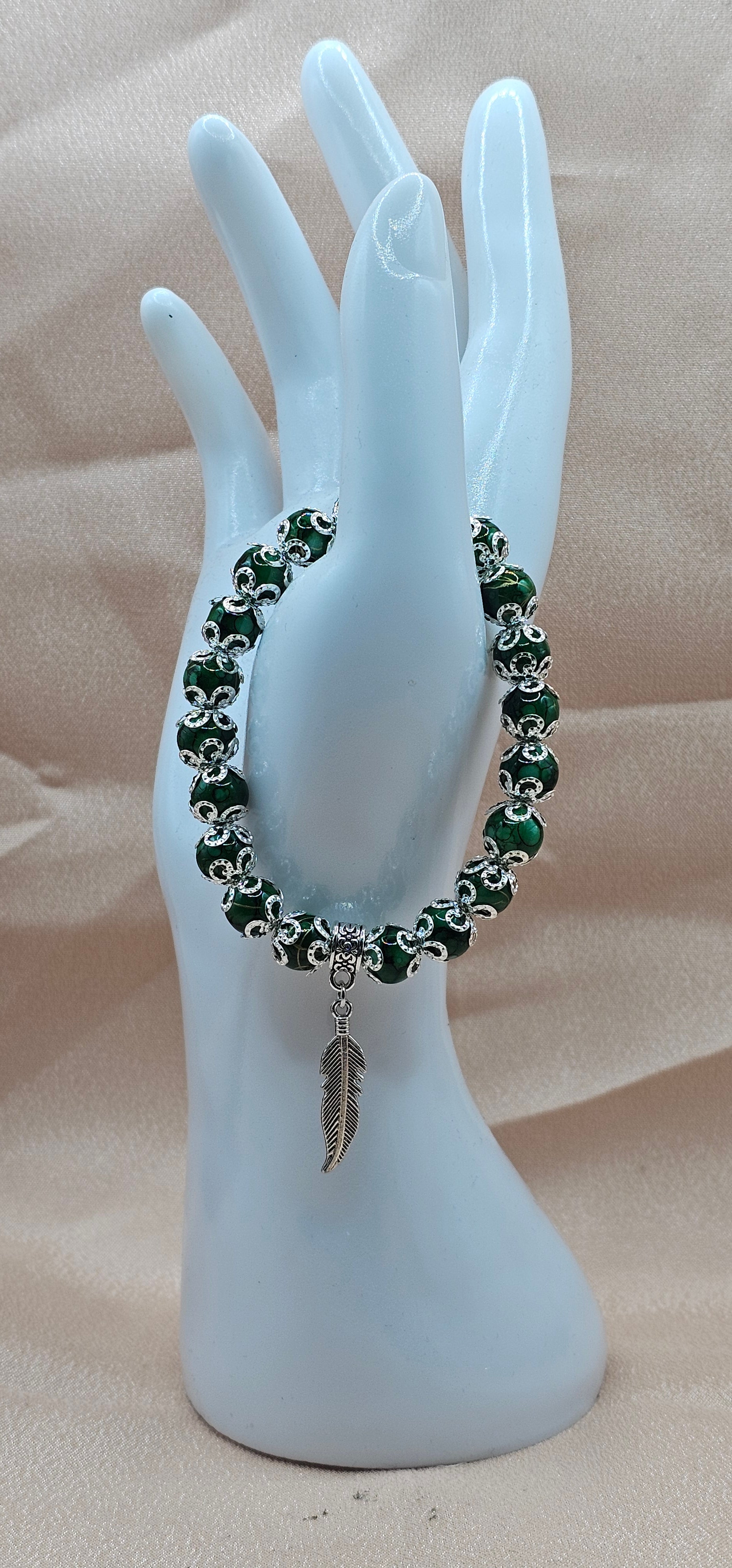 Handmade green marbled beaded bracelet with silver feather charm and filigree, green witch jewellery Australia