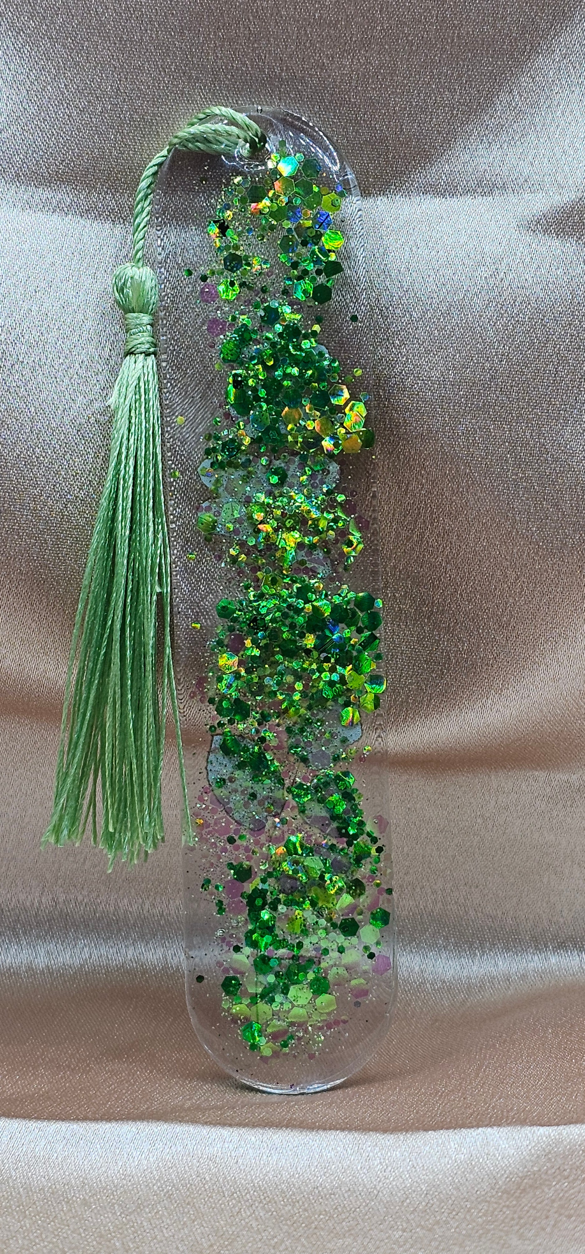Handmade enchanted forest resin bookmark with real pressed ferns, holographic glitter & sage tassel. Cottagecore & fairycore book accessory handmade in Australia.