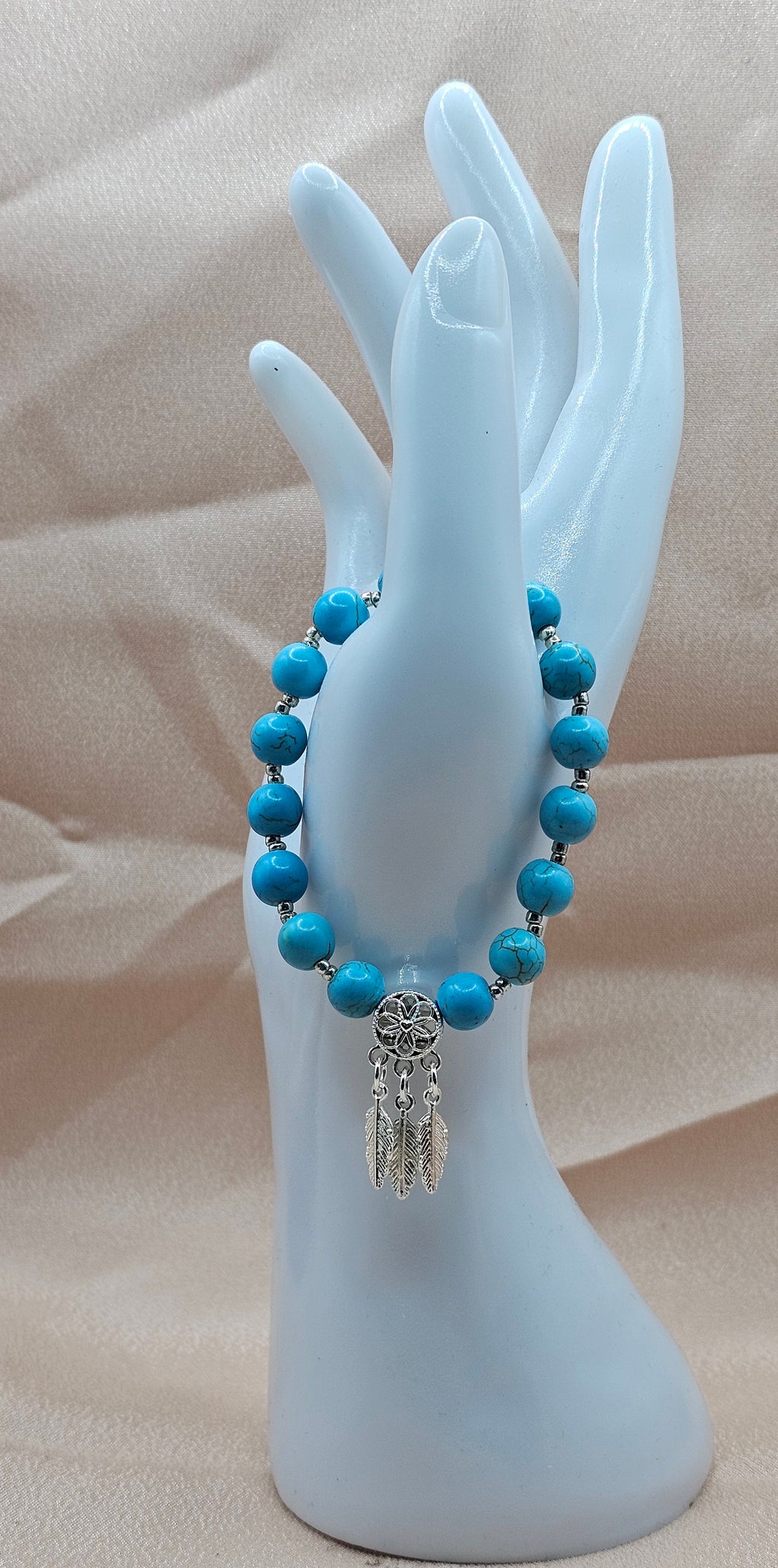 Handmade turquoise dreamcatcher bracelet with feather charm cluster and silver spacers, boho jewellery Australia