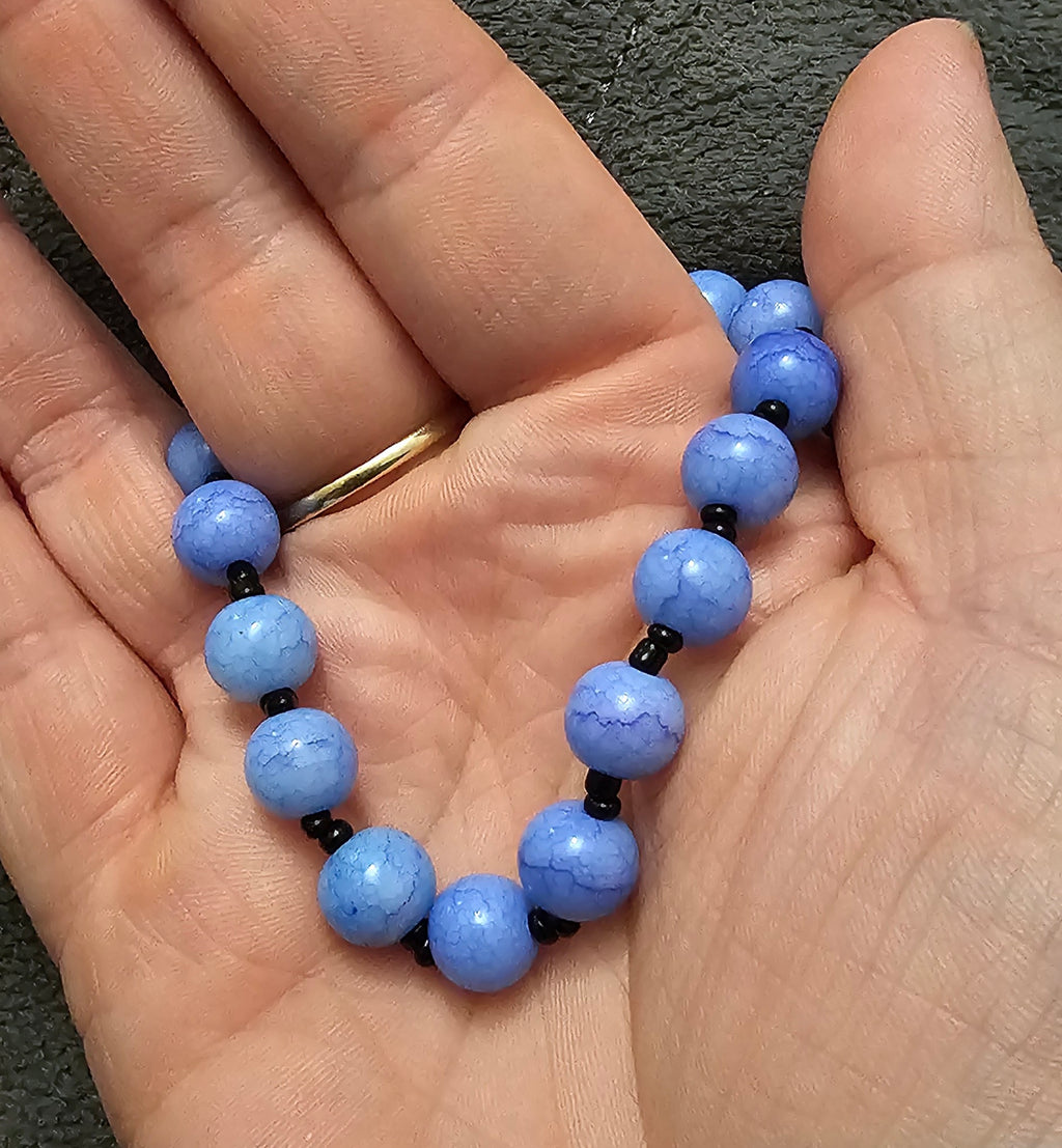 Handmade blue beaded bracelet with faceted sky blue and black accents, mooncore jewellery Australia